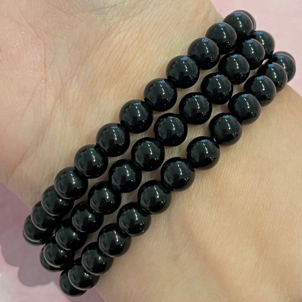 Black obsidian bracelets layered on a wrist