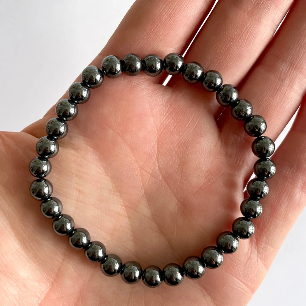 Metallic hematite bead bracelet resting in a hand