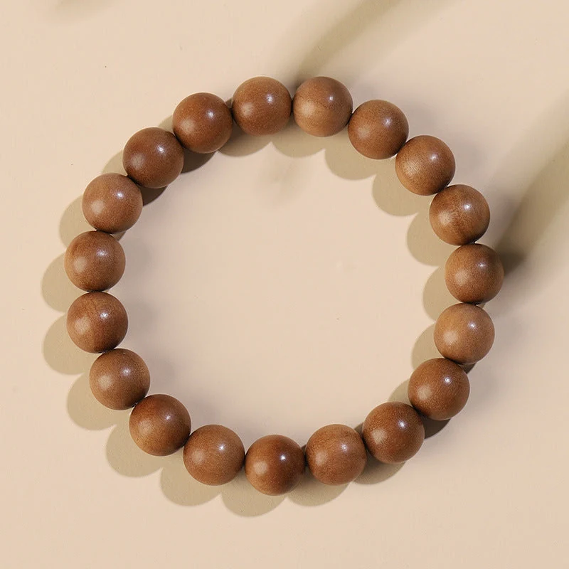 Sandalwood bead bracelet on a warm ivory surface